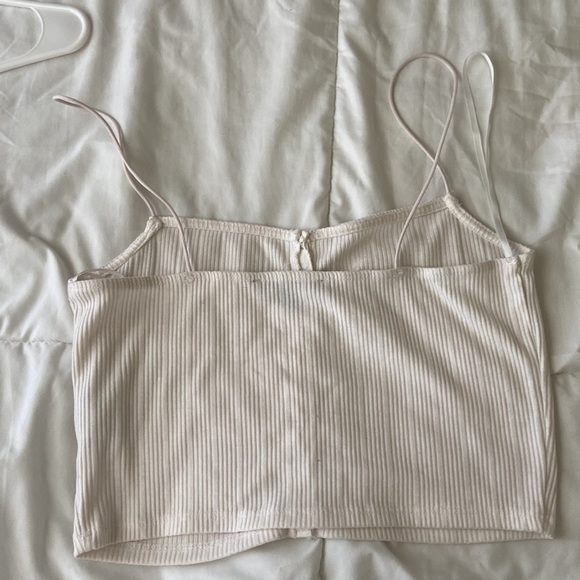 This is a medium sized white cropped tank top with a button down. - Picture 2 of 4